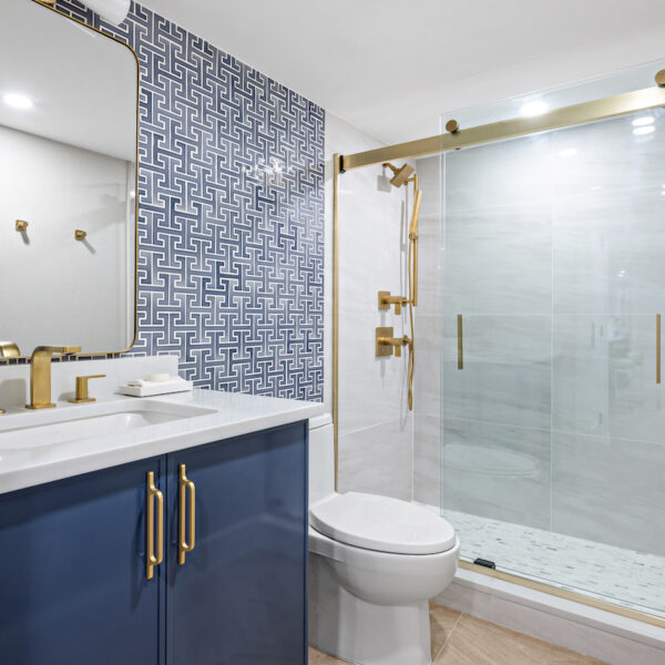 Bathroom with blue vanity, white countertop.