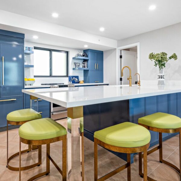Kitchen with blue island, green stools.