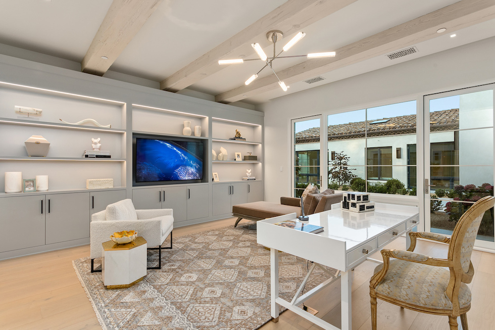 modern Southern California home office with built-in cabinets, white desk and chair.
