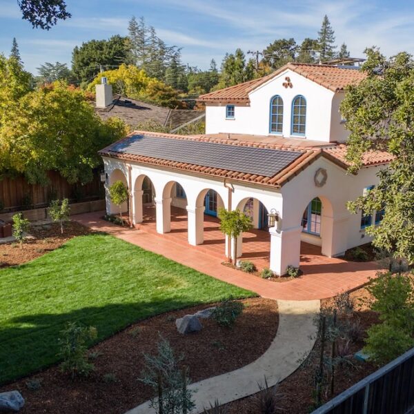 Northern California home with tile roof, white exterior and arched windows.