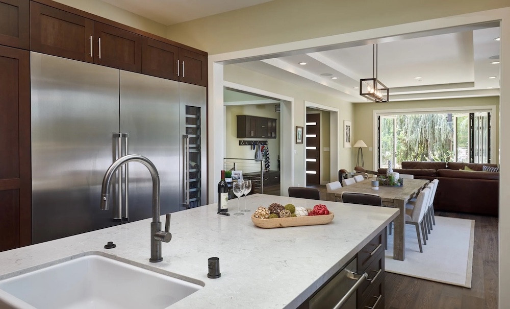 Interior design and architecture in Northern California kitchen with marble countertops and brown cabinets.