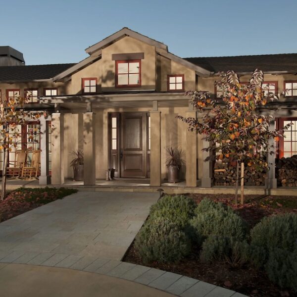 Northern California home with brown facade and red windows frames.