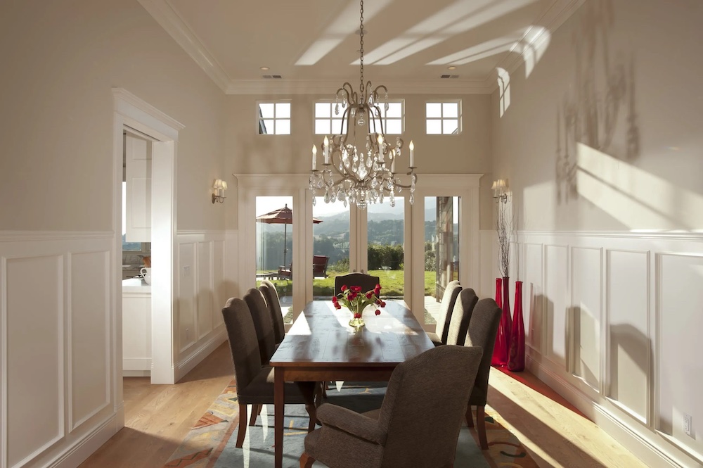 Interior design and architecture in Northern California dining room with wood table and crystal chandelier.