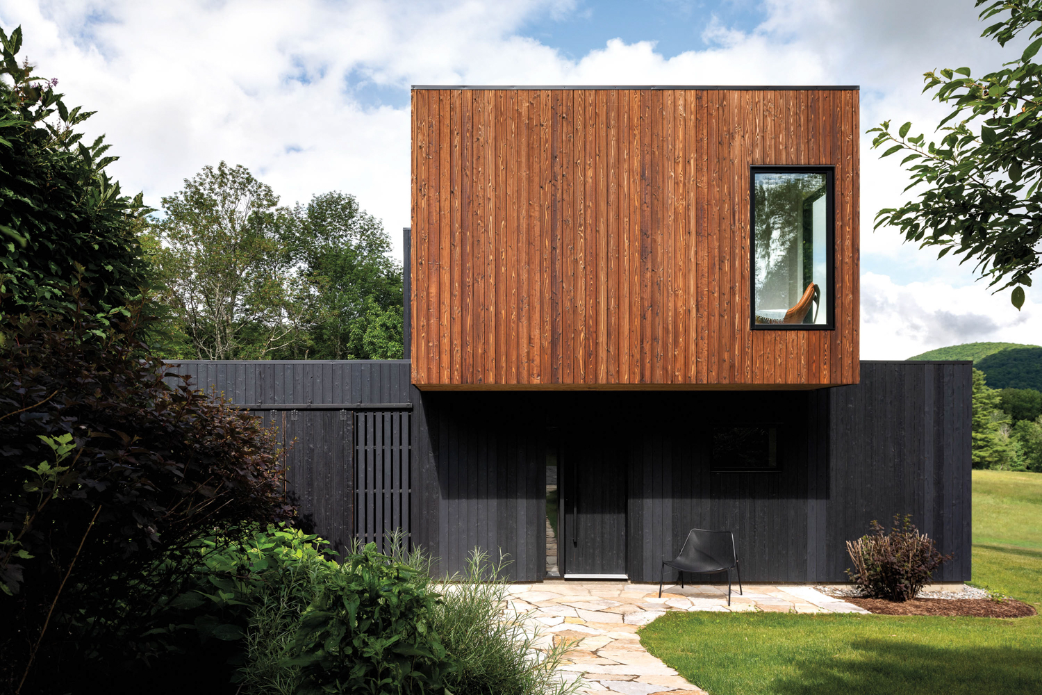Exterior of house with dark wood cladding and black, burnt-wood siding by Nakamoto Forestry