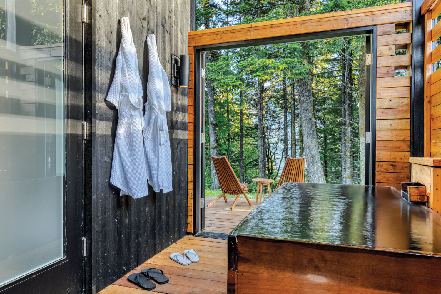 Wood cabin with private soaking tub overlooking forest views at Tenzen Cabins & Springs