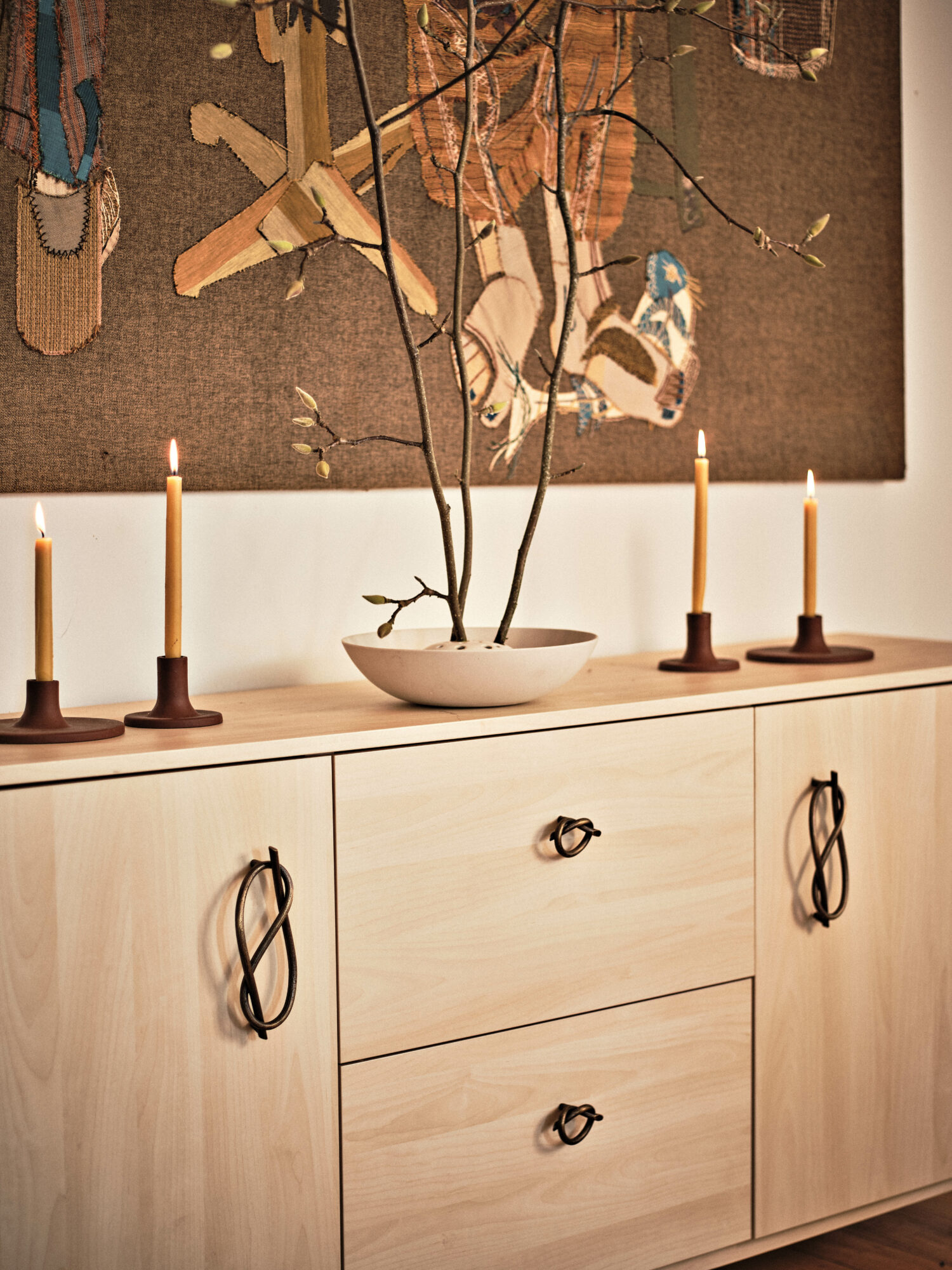 Sideboard with brass knobs, candlesticks and deco branches, part of Katie Gong x Nest Studio collab