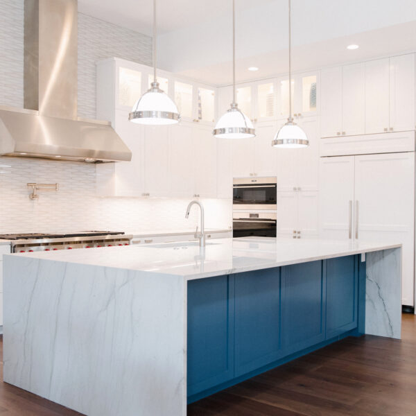 white kitchen with blue island accent