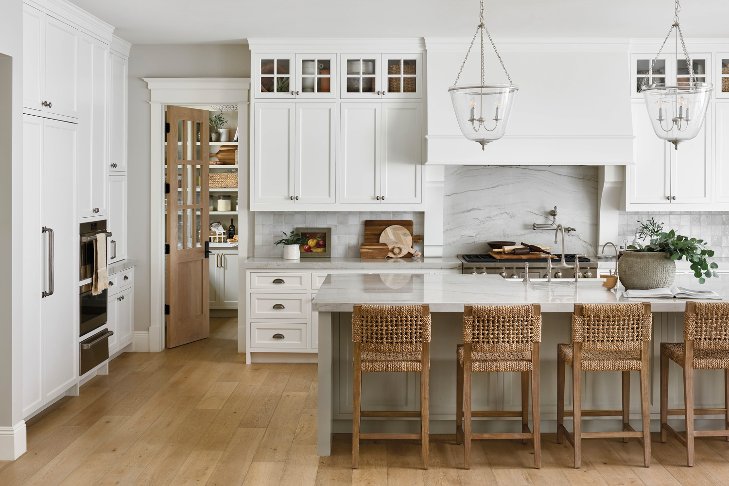 All-white kitchen with quartzite counters,...