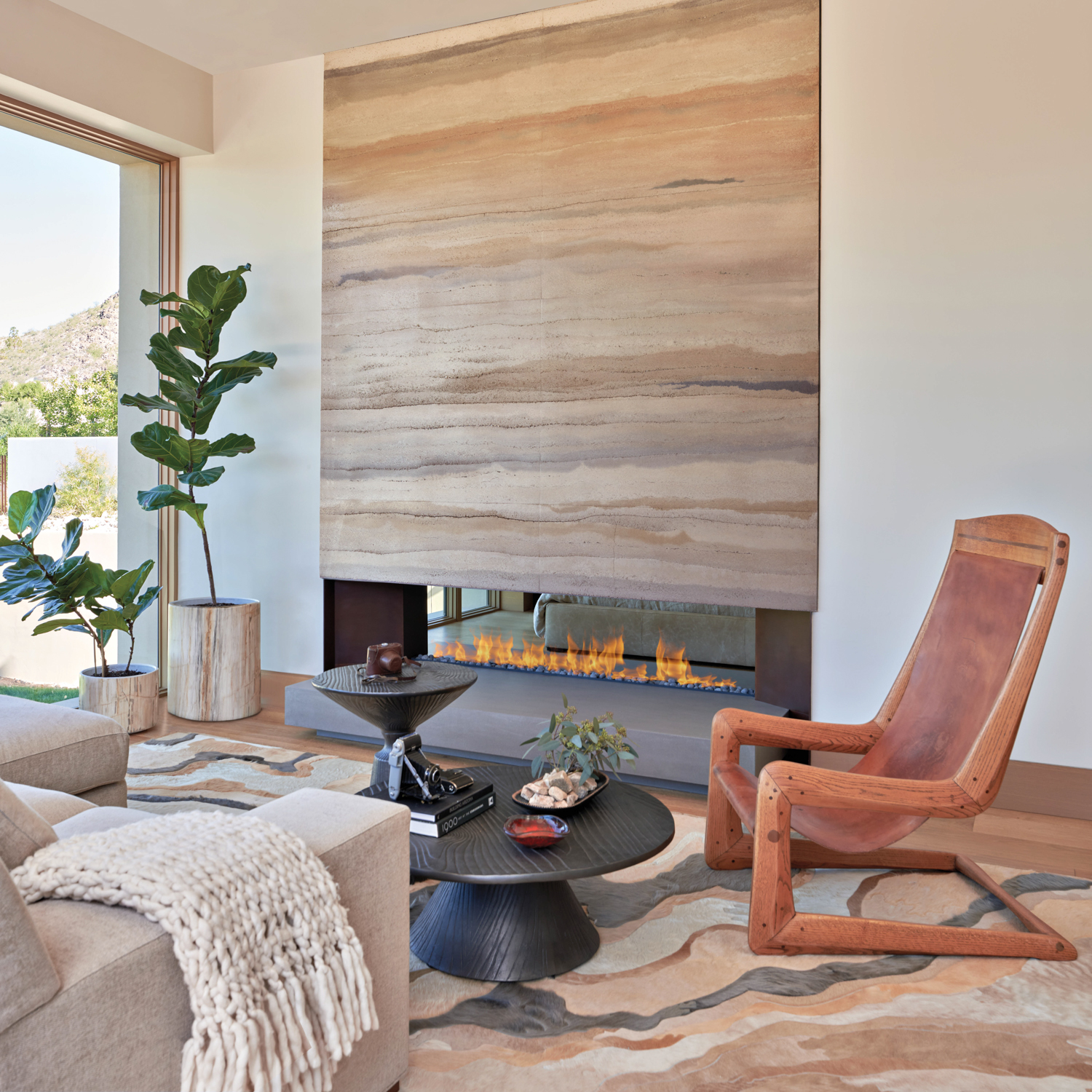 Room with rammed-earth fireplace, a...