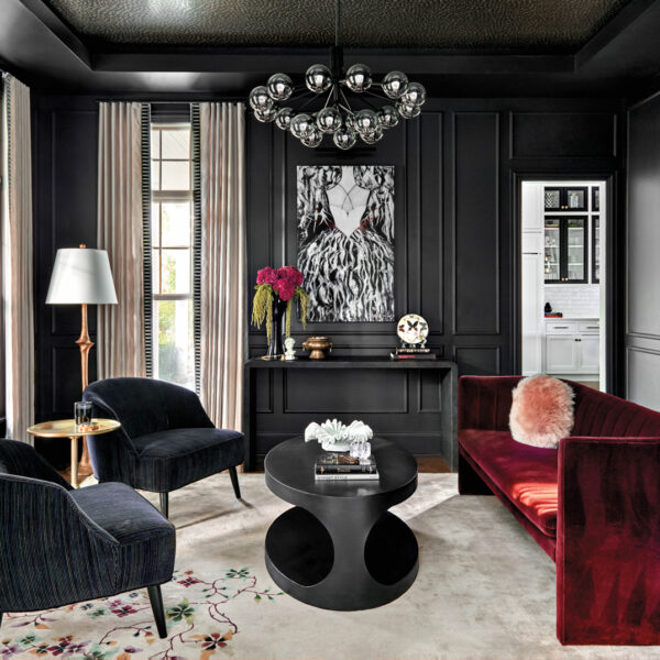 black parlor with a red velvet couch, lounge chairs and black-and-white painting in home by Mia Rao
