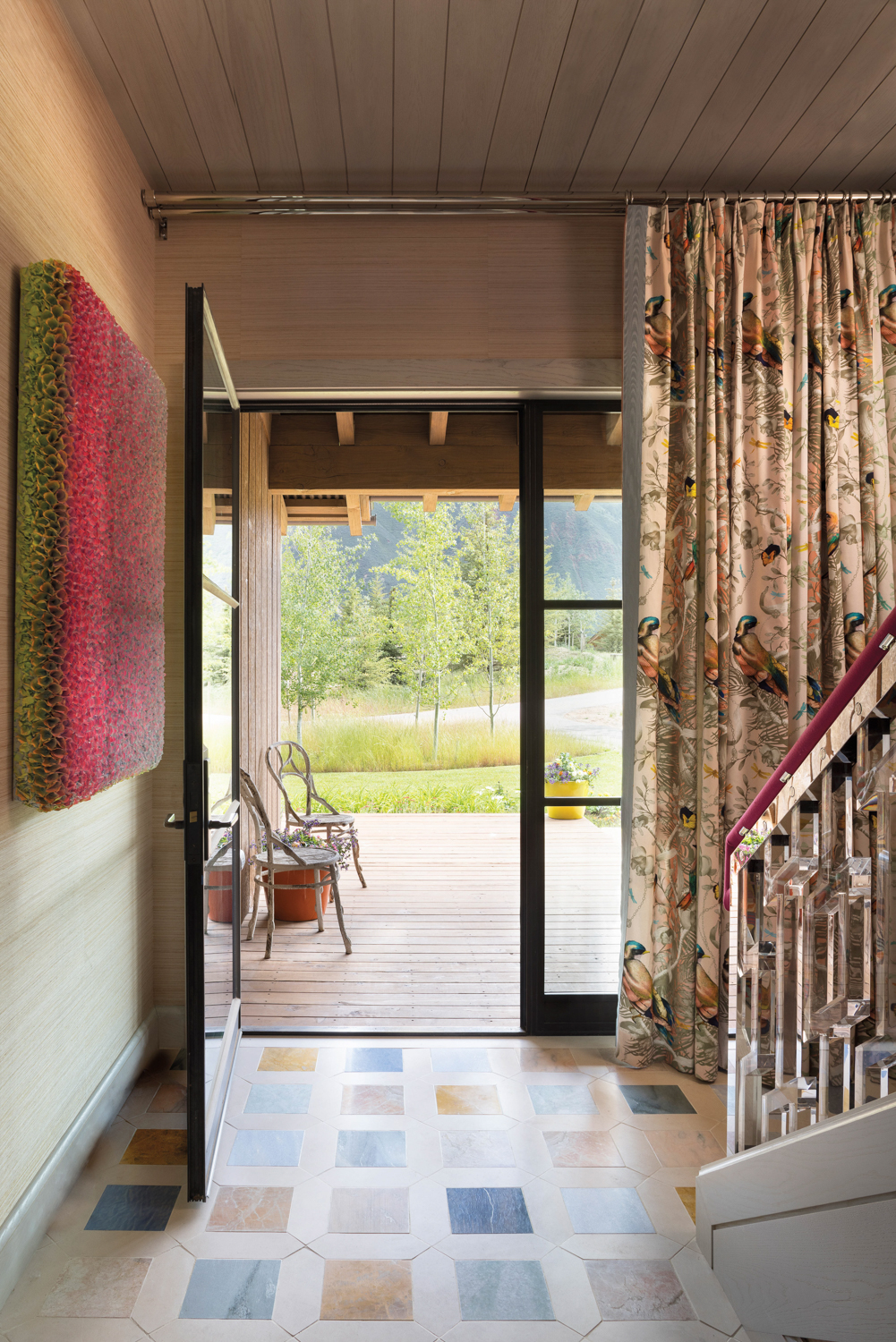 entryway with bird-printed draperies and...