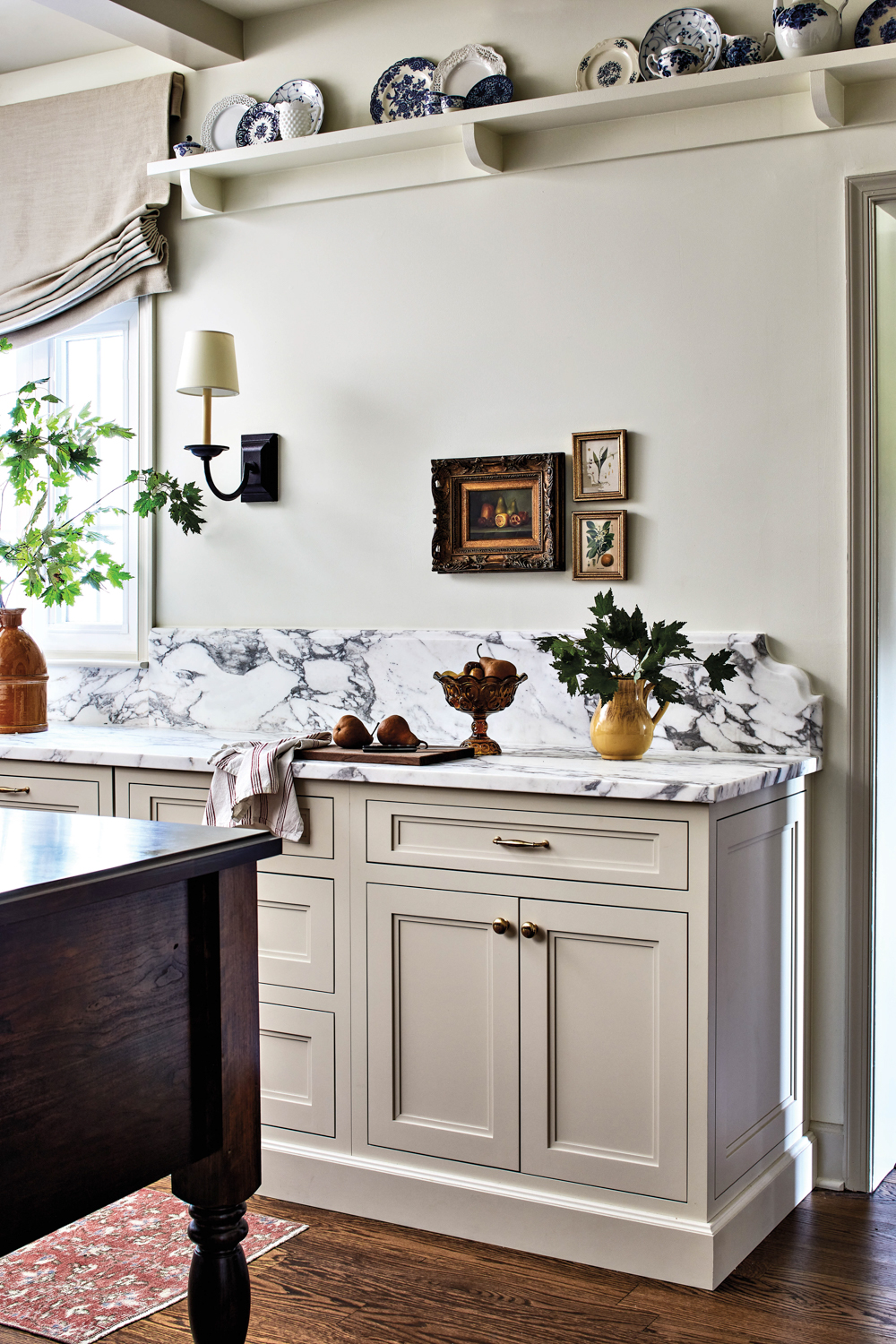 white kitchen cabinets with marble top and built-in shelves by Winsome Interior Design