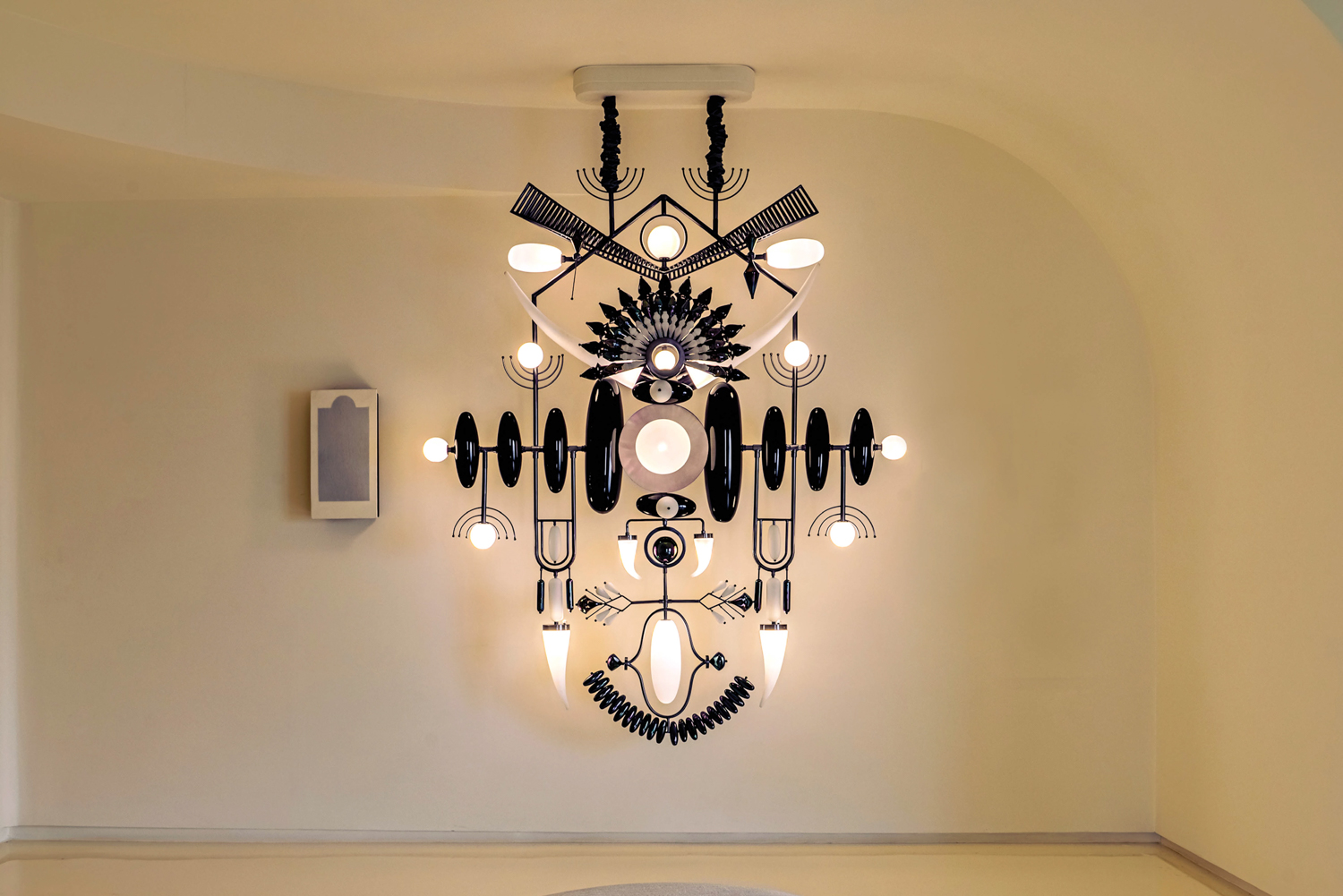 black and white symmetrical light fixture with totems from Klove Studio