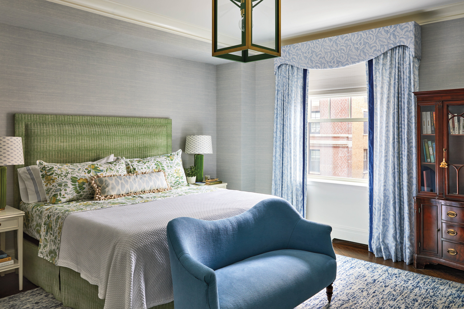 traditional bedroom in a blue-green...
