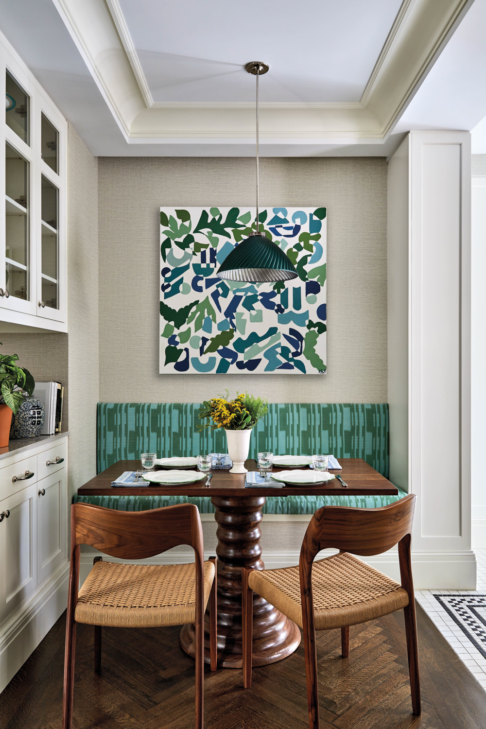 breakfast nook with green banquette,...