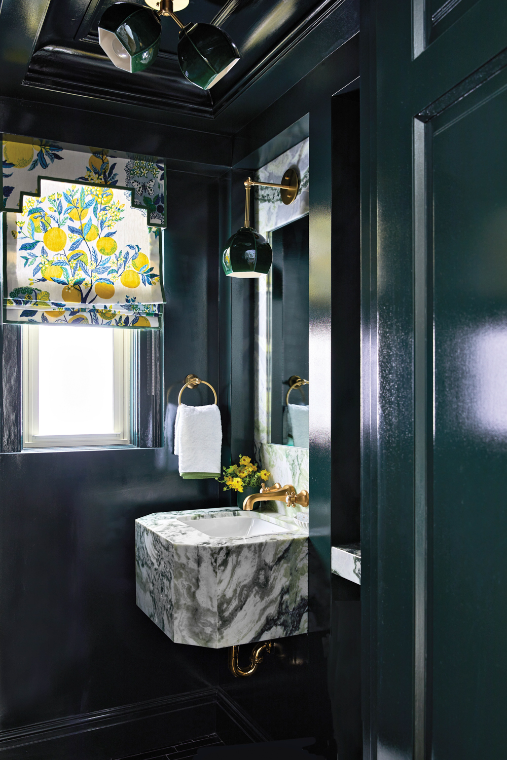 glossy blue powder room with...