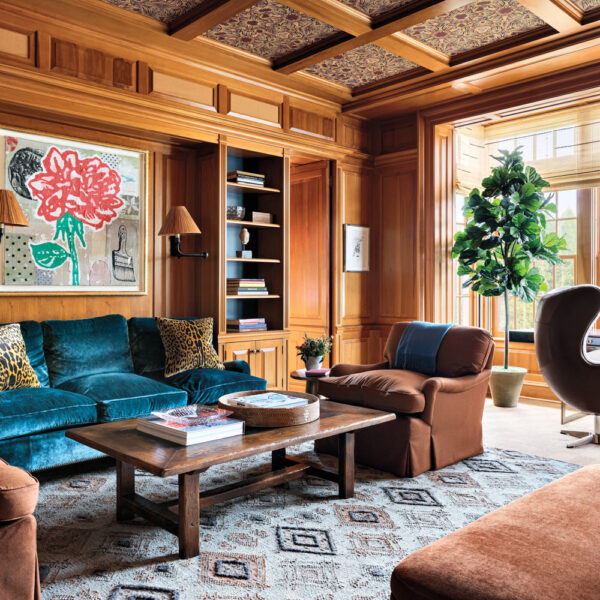 wood-paneled den with velvet teal sofa in a Connecticut home