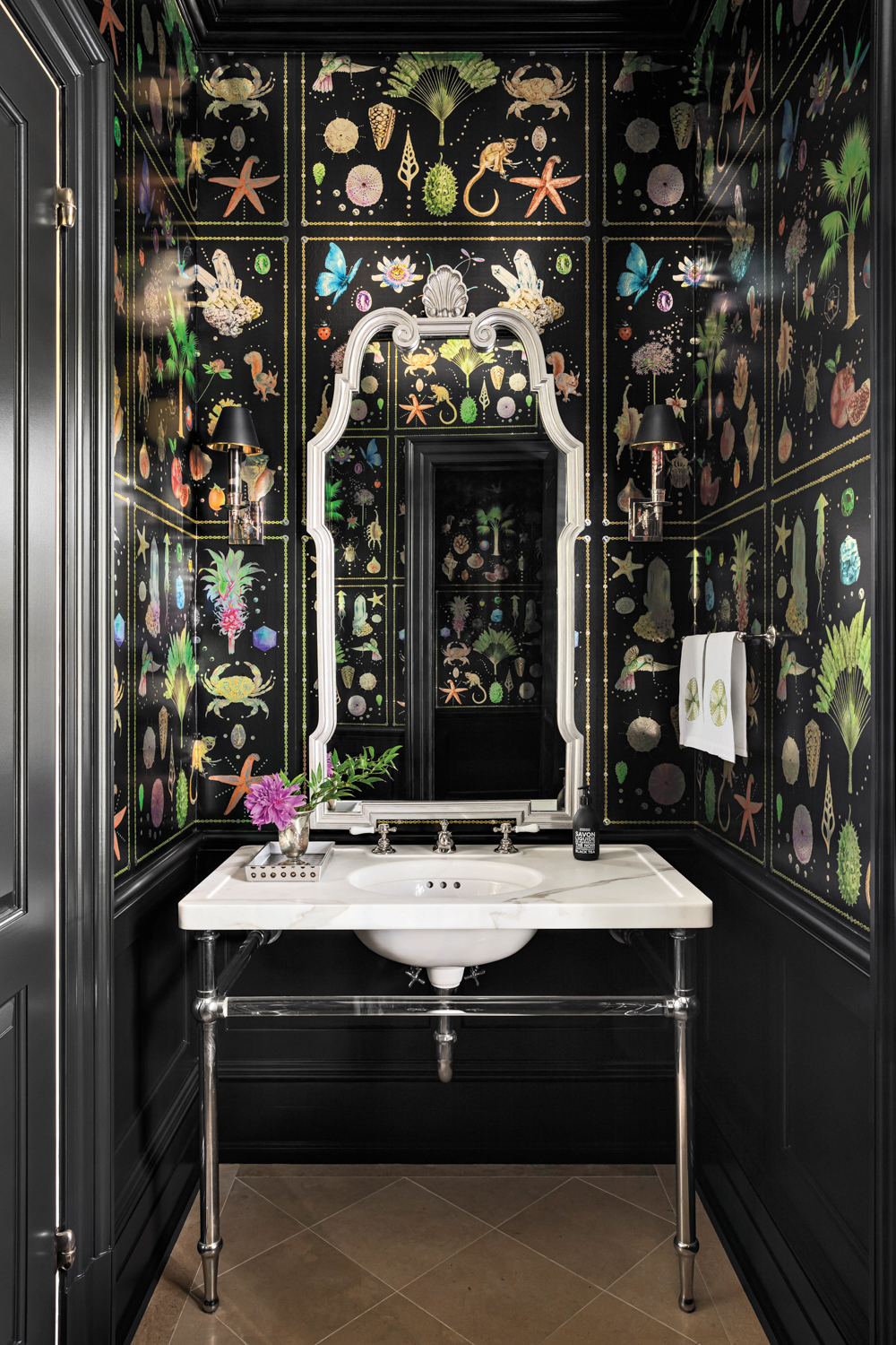 black powder room with holographic...