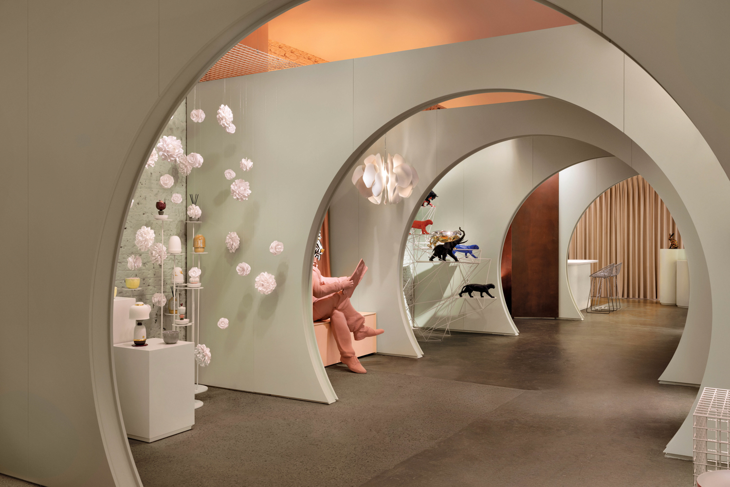 Lladro store interior with porcelain figurines on display on the sides of circle-shaped arches
