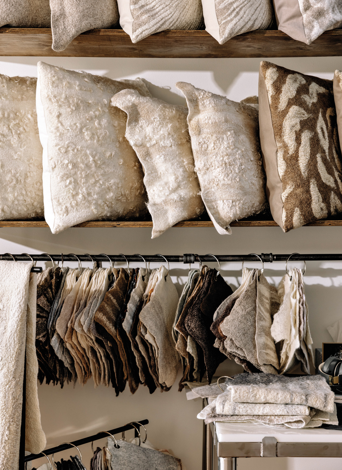Decorative pillows and pieces of fabric hanging on a shelf