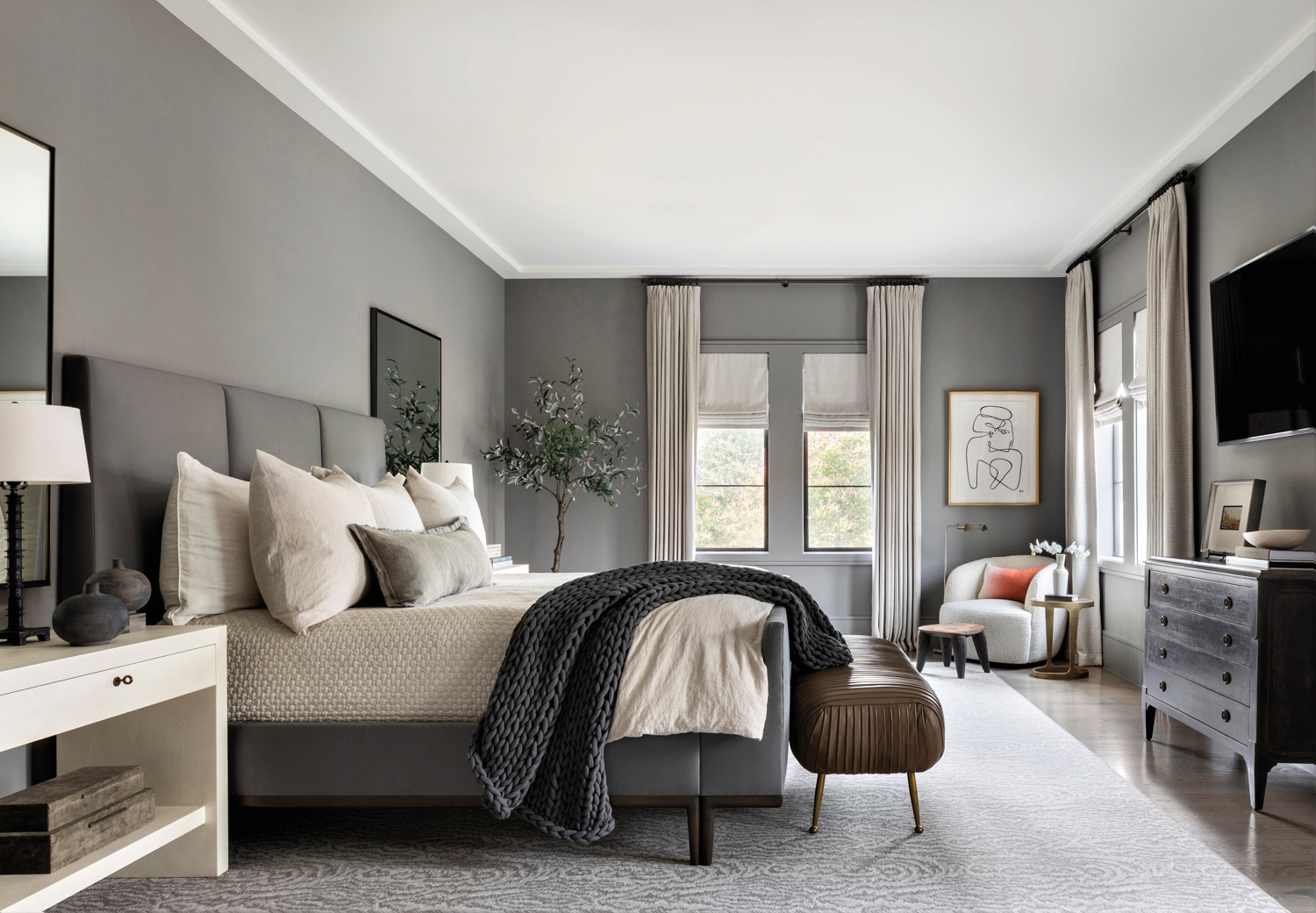 monochromatic bedroom featuring gray walls...
