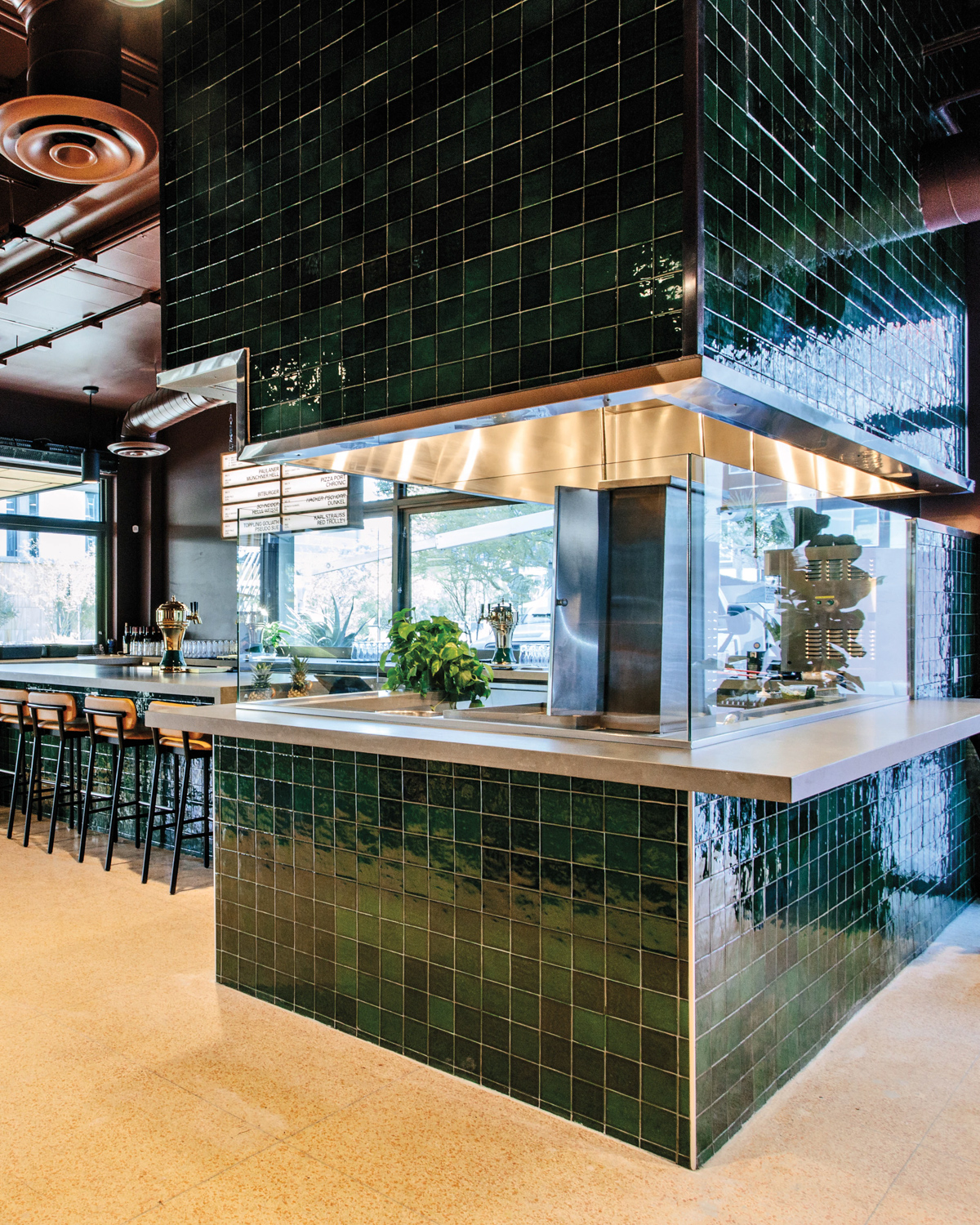 island kitchen with green tile, bright lights and lots of space