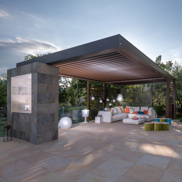 modern outdoor patio with white sectional sofa and motorized pergola