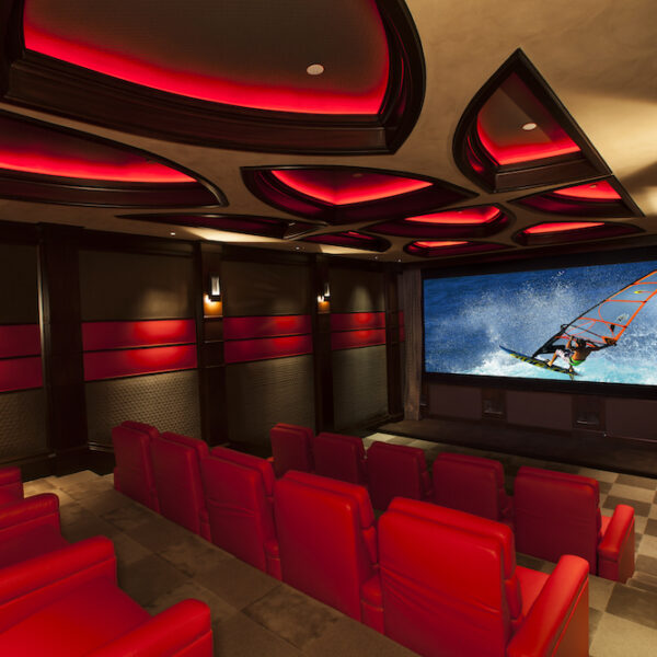 home theater with red reclining chairs and walls