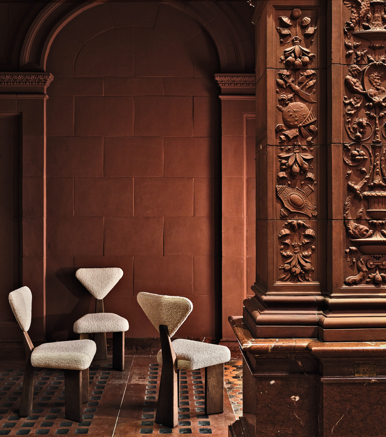brown wall with arches and white chairs at the Hispanic Society Museum & Library
