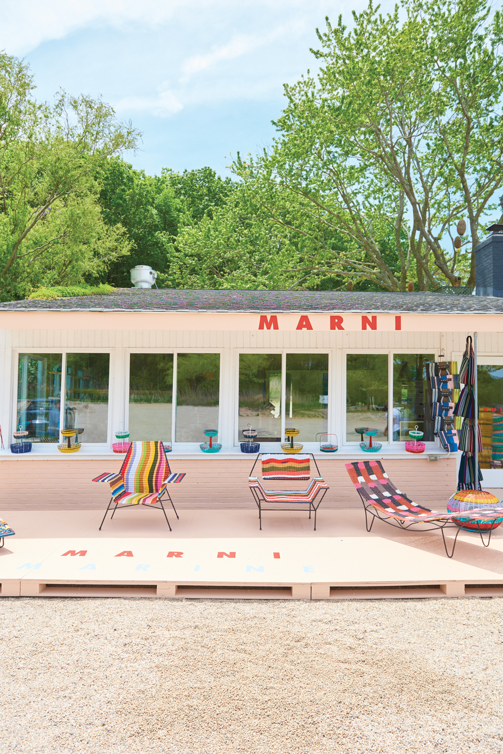 colorful woven furnishings on top a deck in the Hamptons