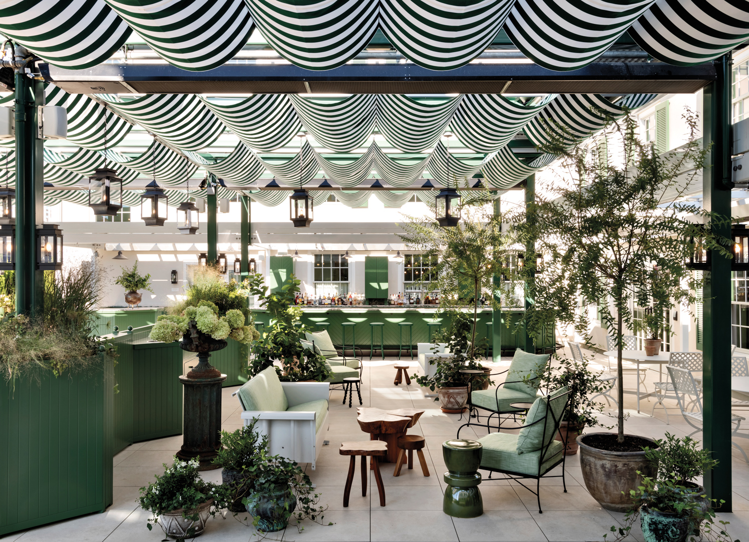 green-and-white interior of mediterranean-inspired restaurant at Canoe Place Inn
