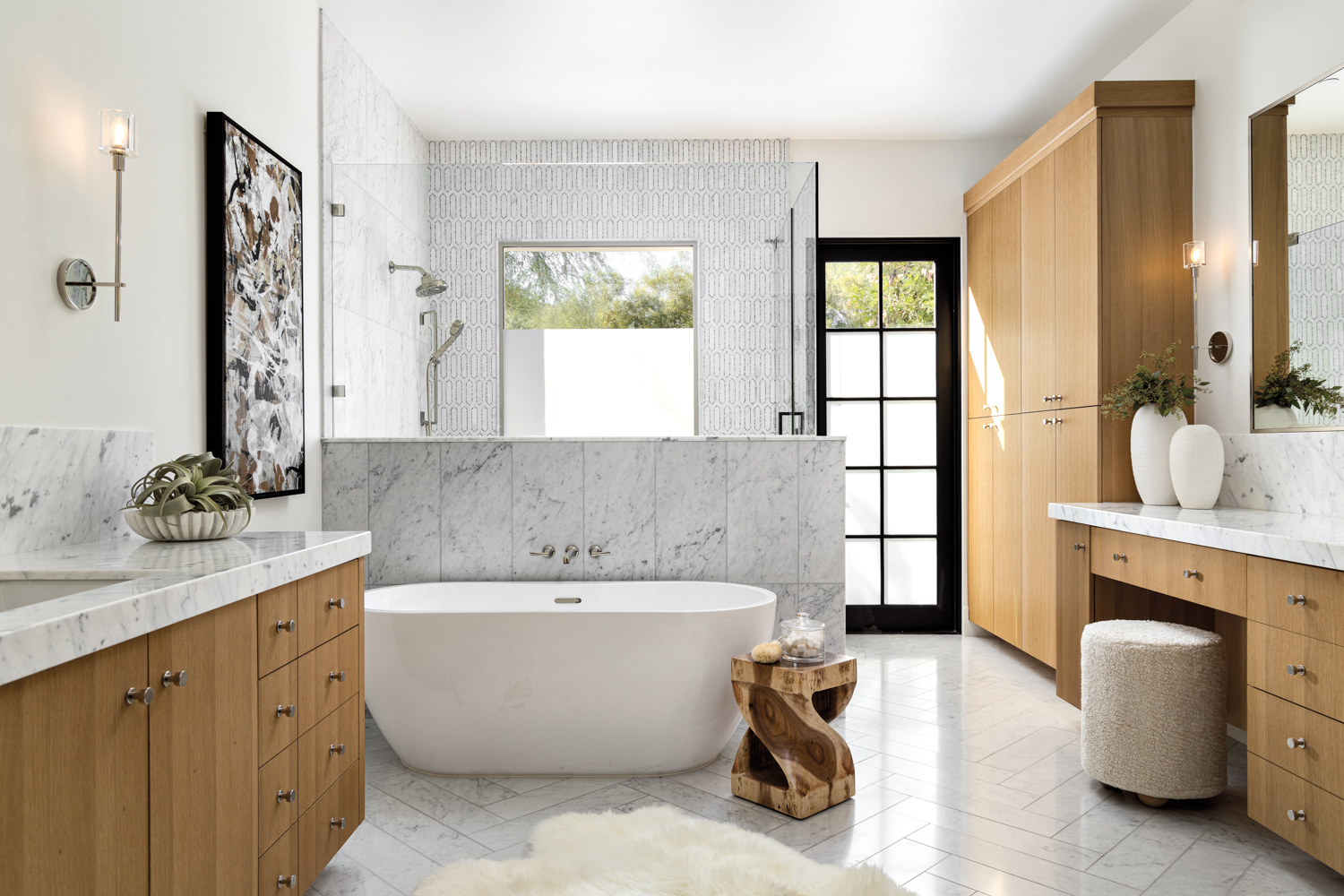 Spa-like bathroom with white oak cabinetry, a freestanding tub and marble floors by Lindsay Kadlick
