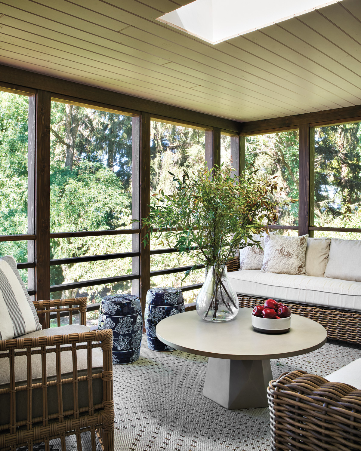 screened-in porch with wicker furniture...