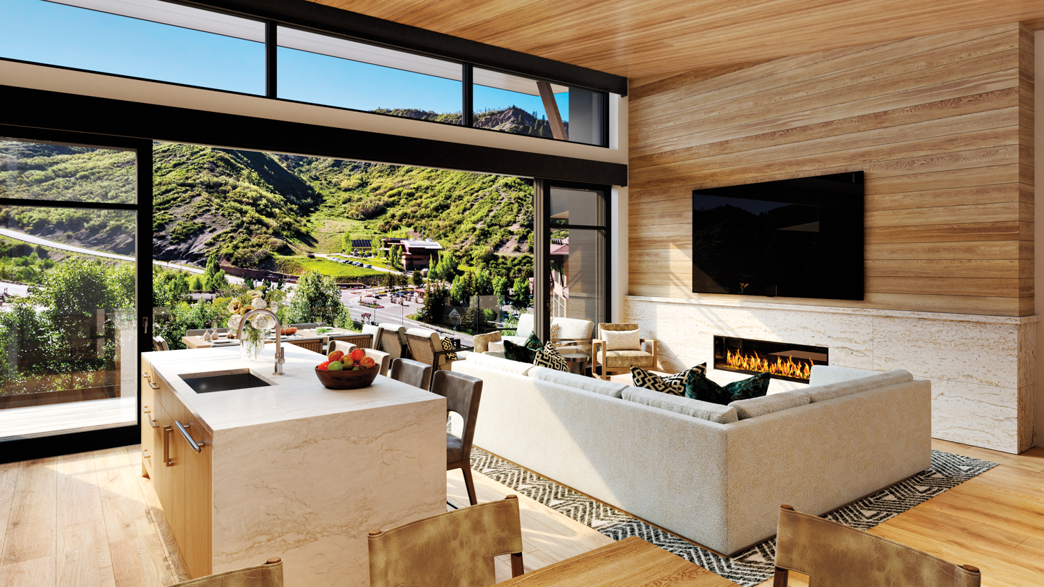 Cirque x Viceroy living room with panoramic mountain views seen through a window wall that opens onto a patio