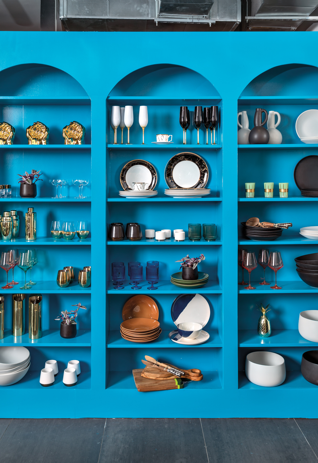 eclectic homewares on vibrant blue shelves in brick-and-mortar shop The Black Home