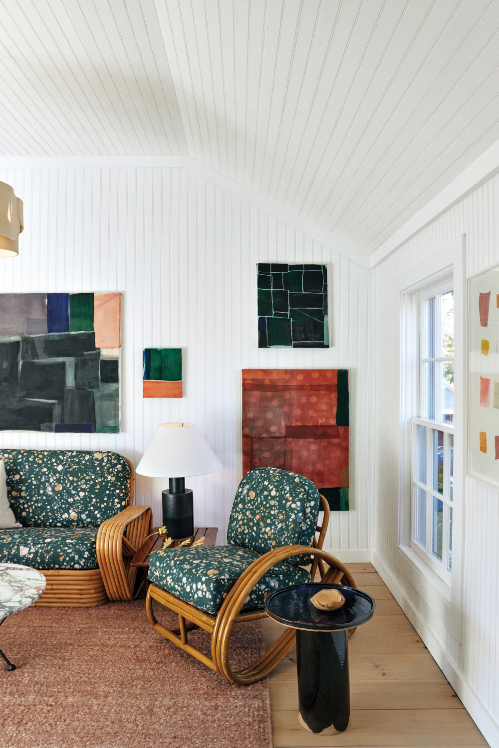 Hamptons art locale Onna House's bright room with green speckled armchairs, square artwork and windows