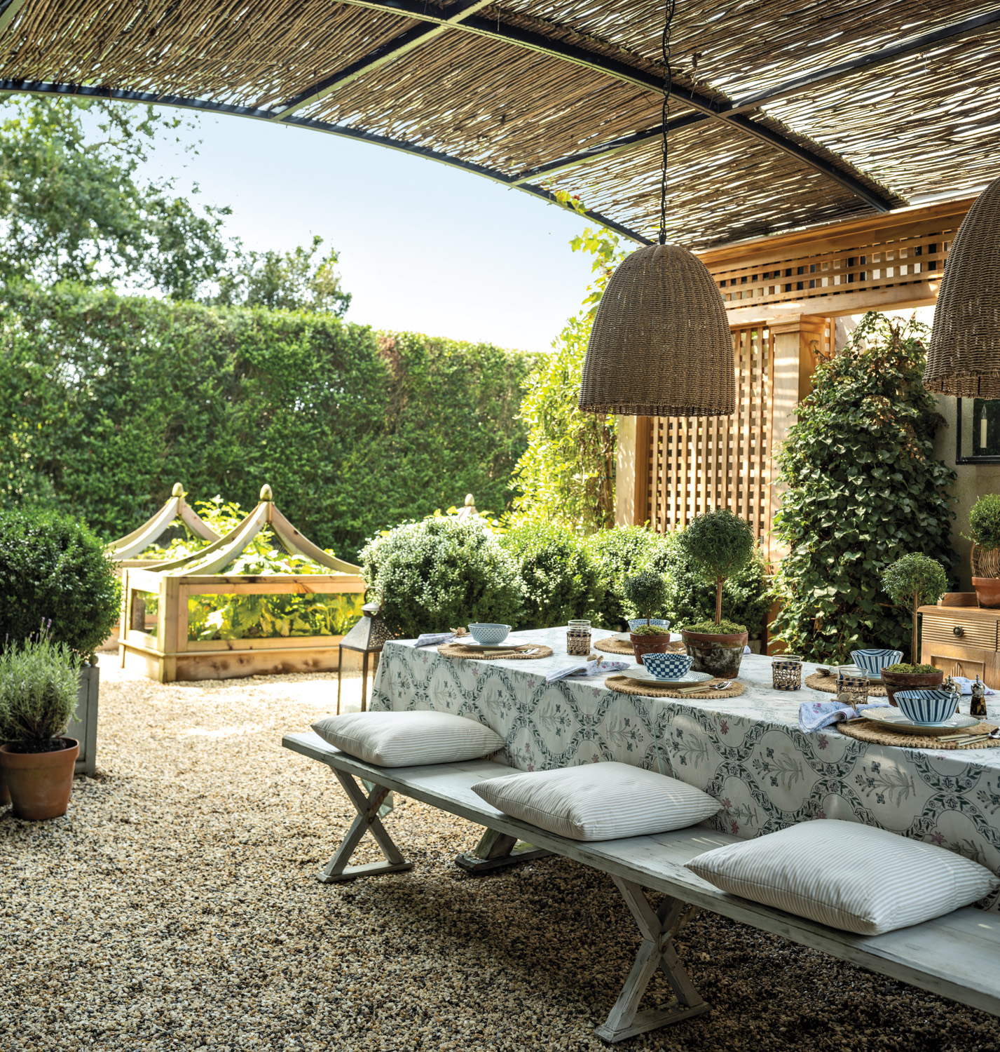 outdoor dining area under a pergola with views to the garden by Matthew Bromley