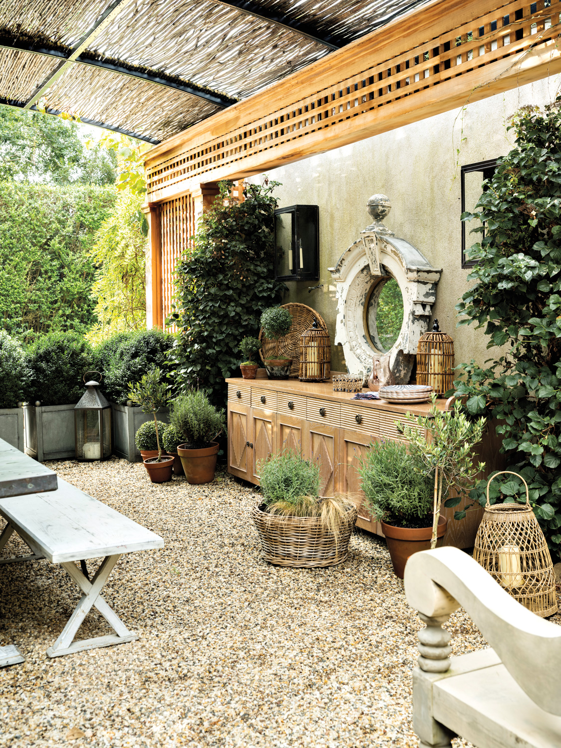 outdoor garden with wooden buffet, antique mirror and tables