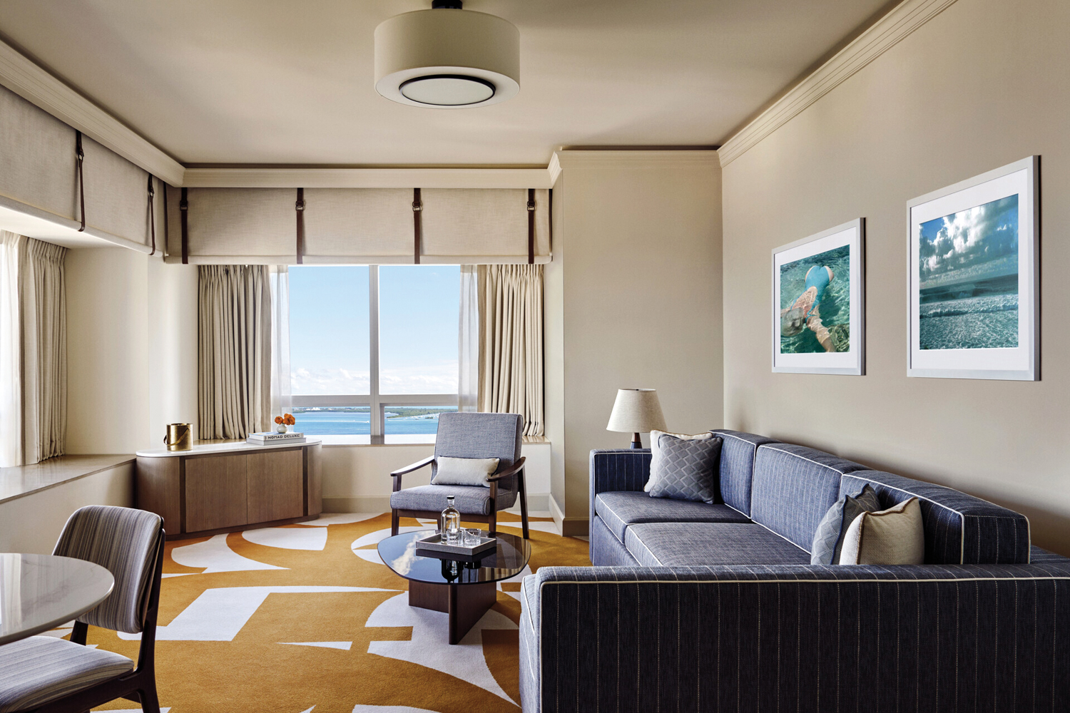 Cream walls provide a backdrop for the midcentury-style pieces in the Four Seasons Hotel Miami
