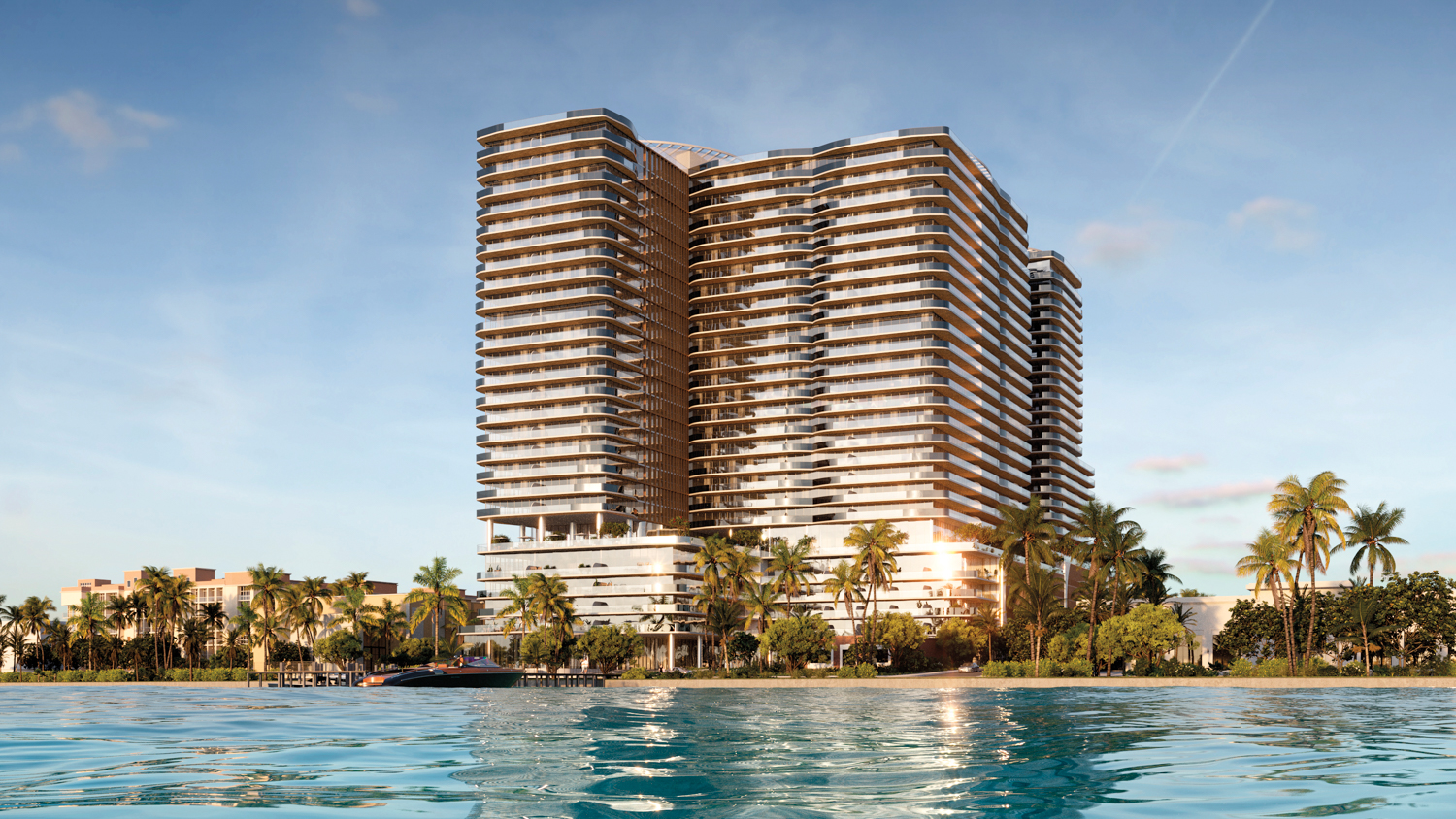 Olara condo tower façade behind a line of palm trees and waterfront