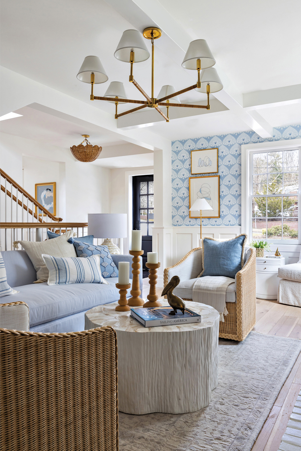 Various living room furnishings on display in a showroom, all in a palette of white and blue