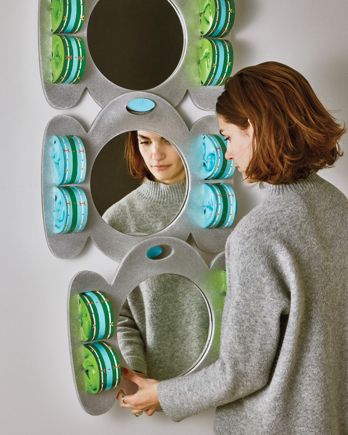 Artist Kiki Got looking into one of her three-piece, amorphous-shaped mirrors