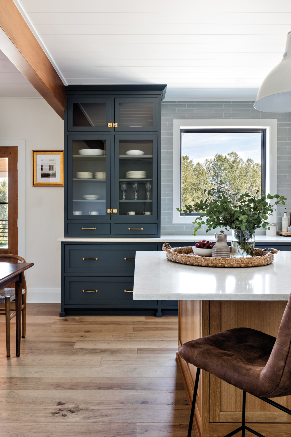 blue-gray kitchen cabinetry with glass...