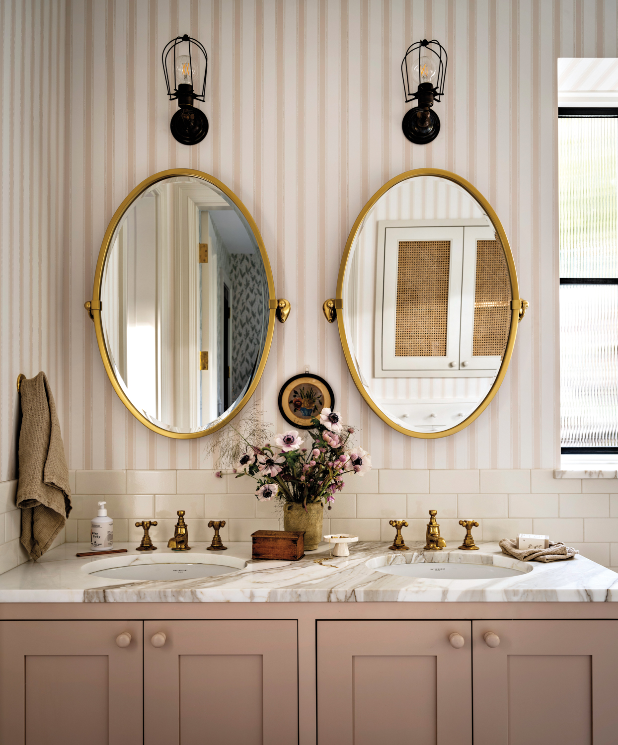 striped wallcoverings line bathroom with...