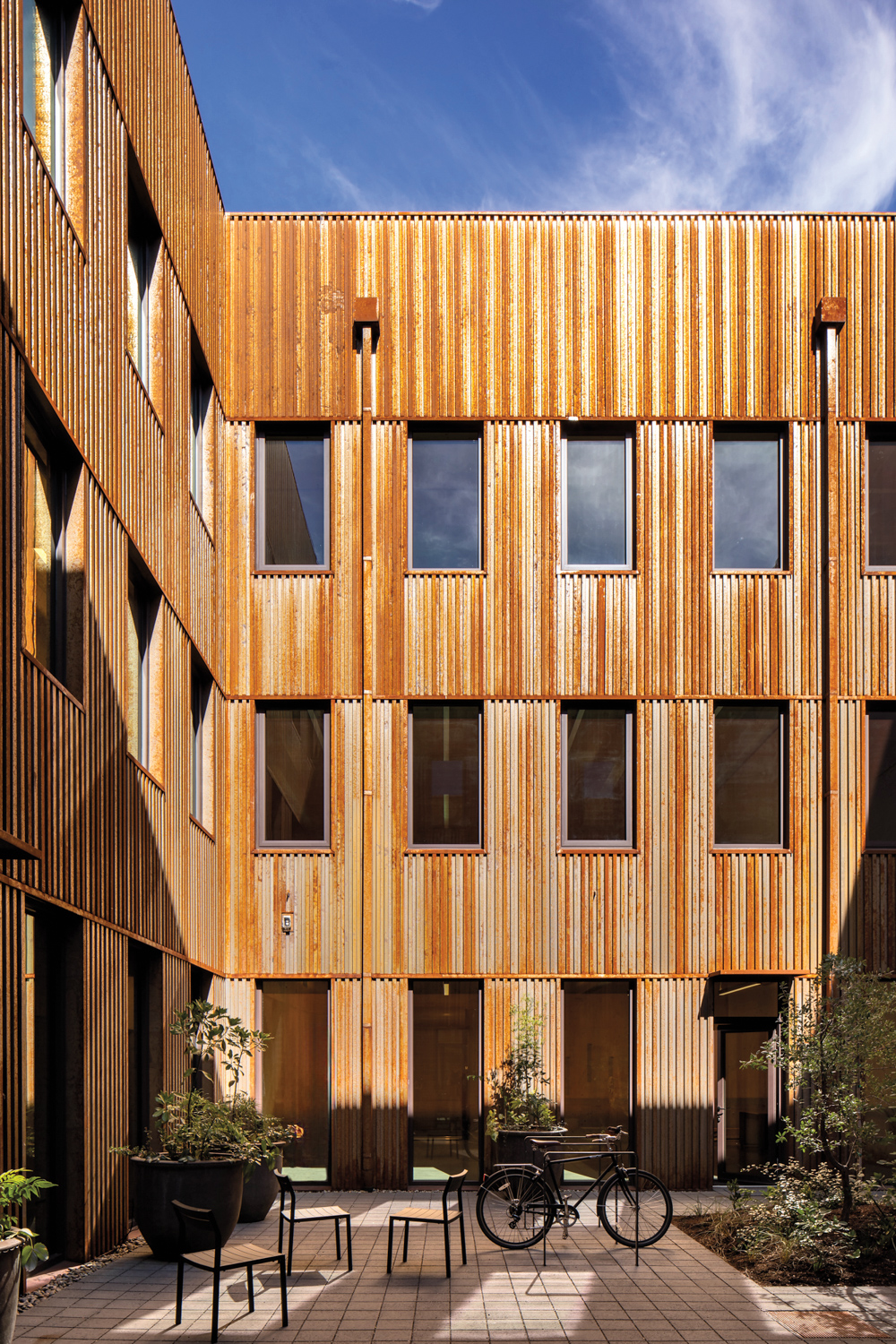 Courtyard of a building made from warm-colored wood panels