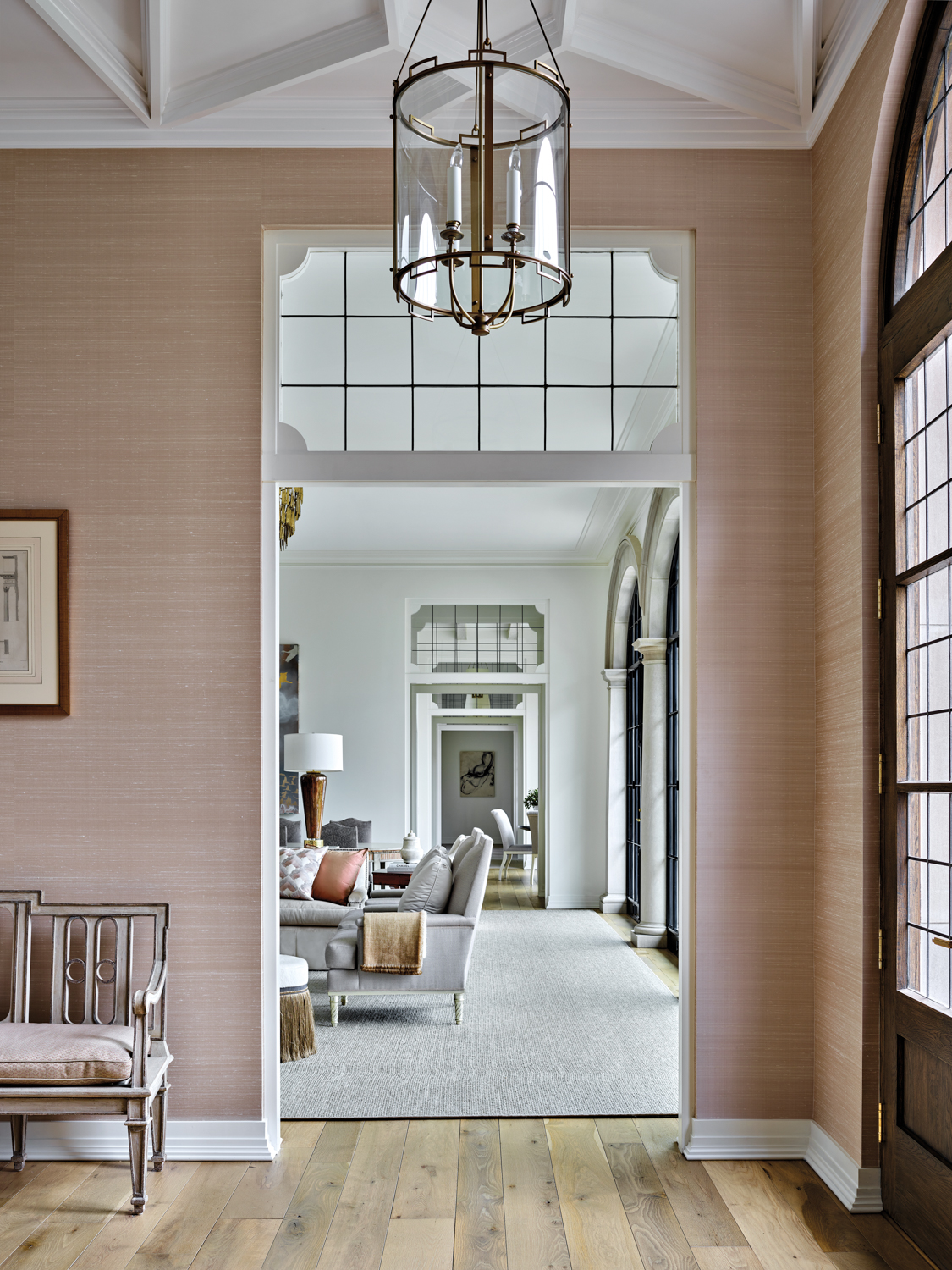 Entryway with blush grasscloth walls,...