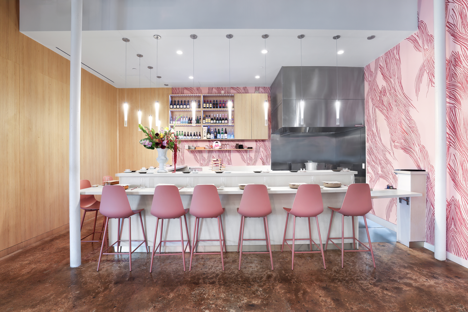 sushi concept with pink chairs and mural