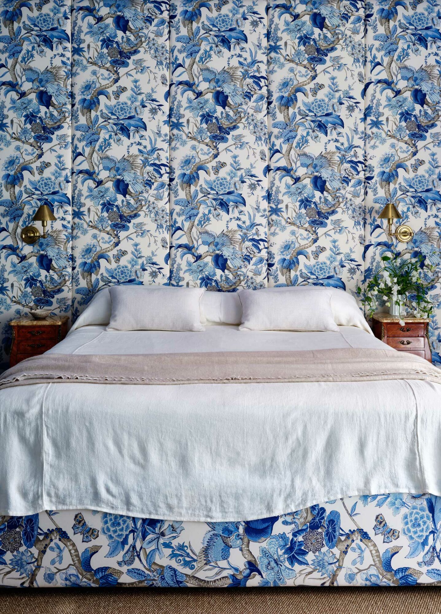 bedroom with floral blue fabric wallpaper matching with floral blue base