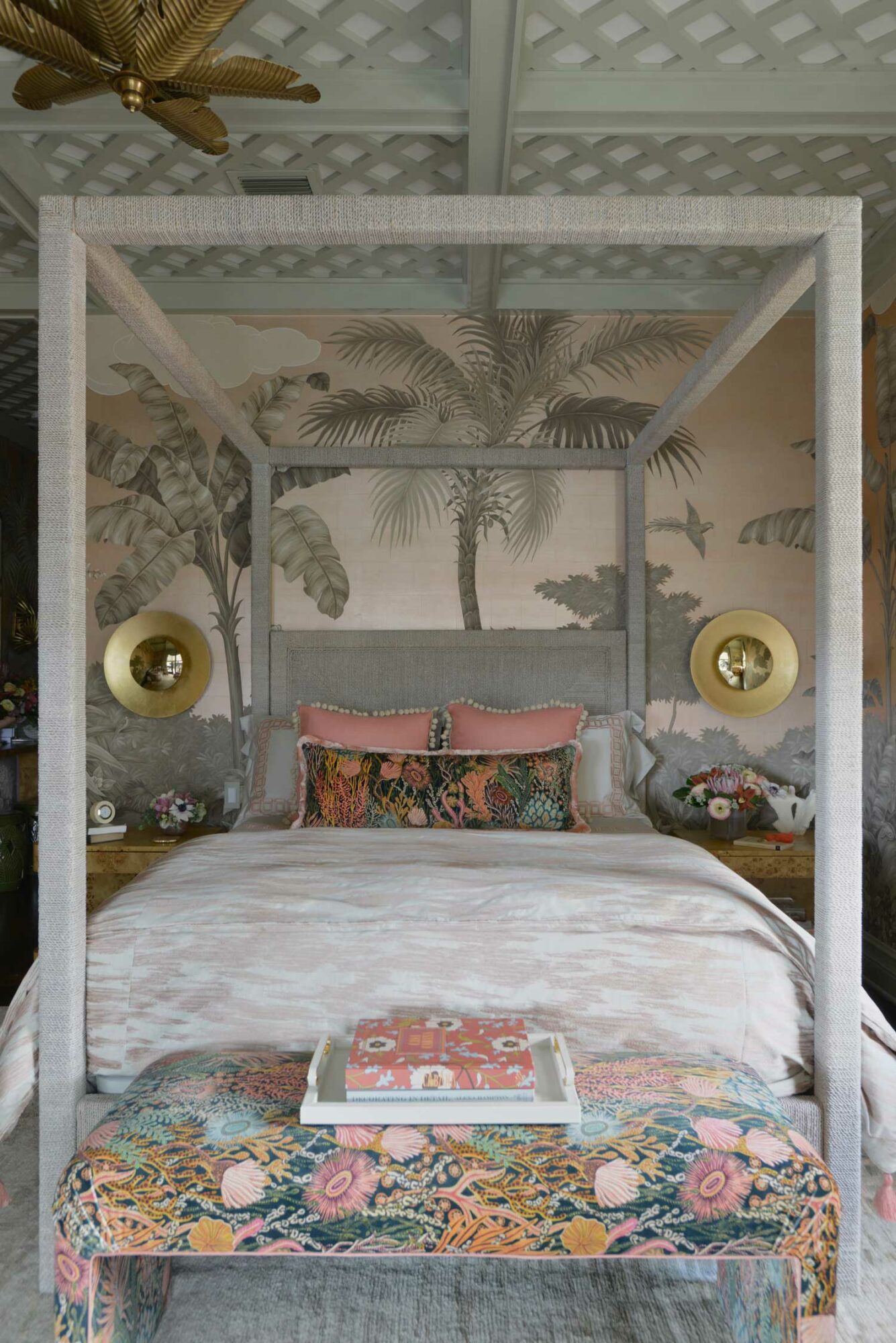 bedroom with palm tree wallpaper and vintage bed and ottoman
