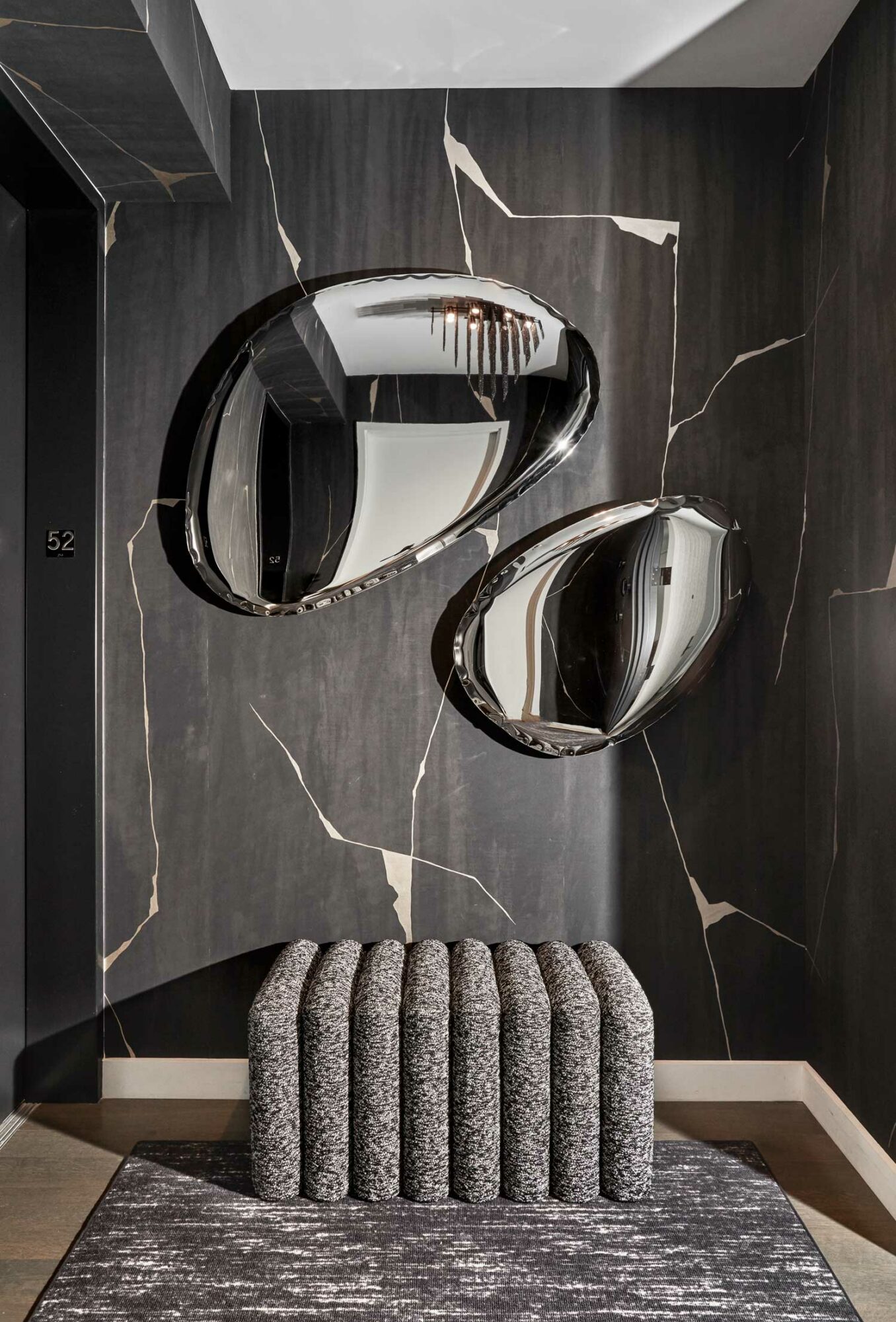 room with one of the 2023 wallpaper trends: textured black wallpaper and stones